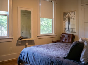 A bedroom with a bed, a window, a door, and a chair. - Masters Rental: 3-bedroom house 1 block to Press Headquarters 1 mile to course (Augusta)