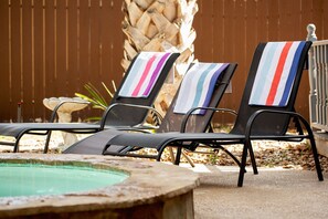 A poolside area with lounge chairs and a small pool. - Family Fun, Heated Pool, Slide, Hot Tub, Game Room (San Antonio)