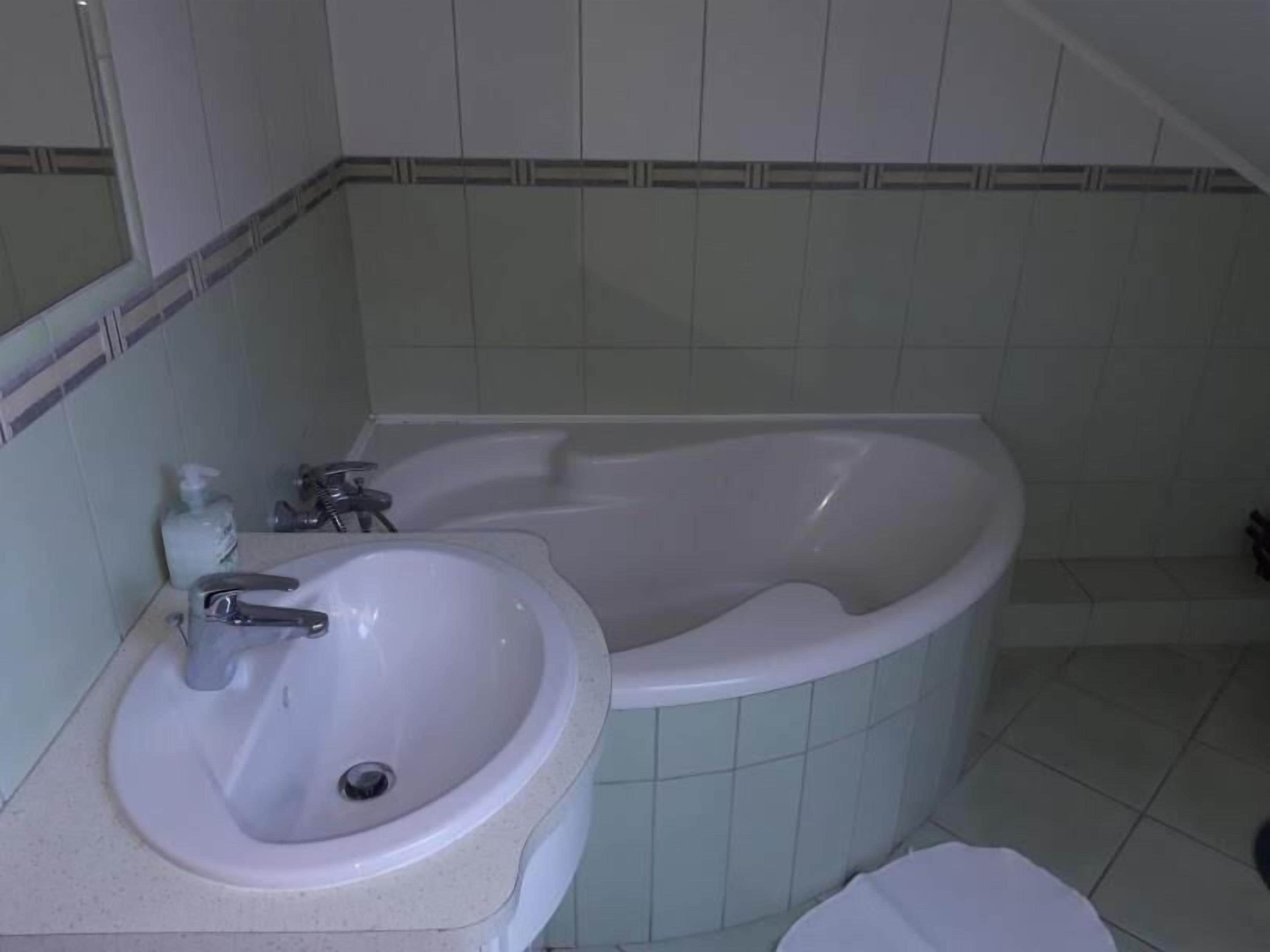 A bathroom with a sink, a bathtub, and a toilet.