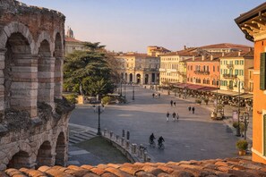 A historic square with ancient ruins, a central open space, and surrounding buildings with traditional architecture. - View of the Arena and Piazza Bra (Verona)