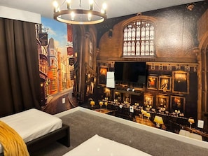 A room with a large mural of a city street, a bed, a desk, and a chandelier. - Themed Rooms 4 BD/ 3 BA/ Storey Lake - 3083 PP (Kissimmee)