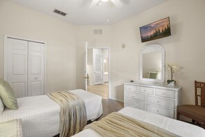 A bedroom with two beds, a dresser, a mirror, and a painting on the wall. - Great Amenities 3 BD/ 2 BA/ Bahama Bay - 605 NP (Davenport)