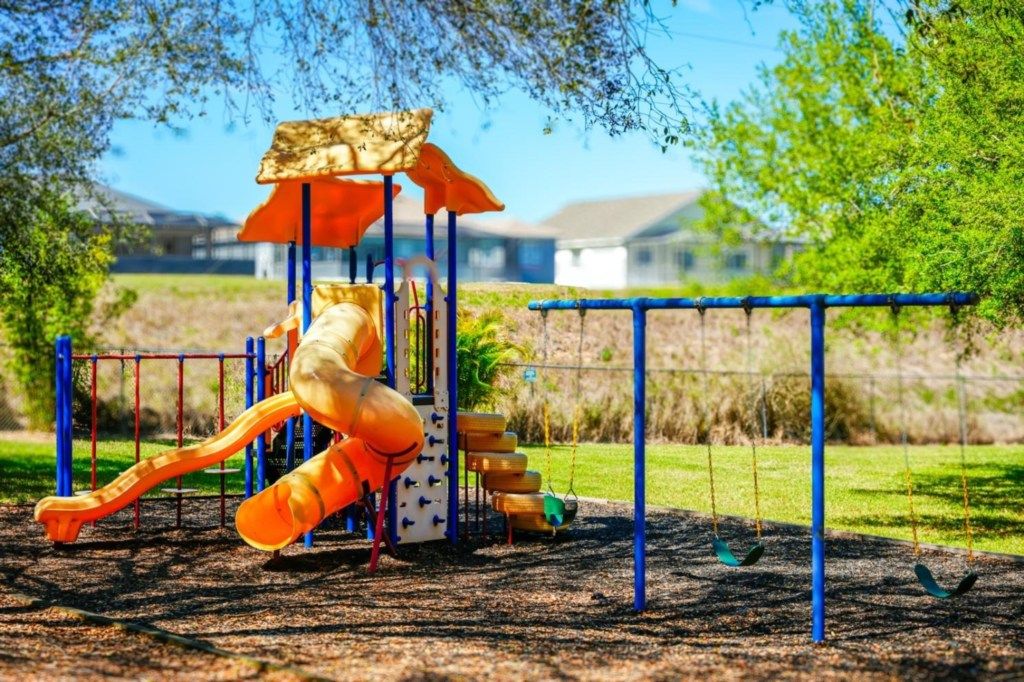 A playground with a slide, swings, and a climbing structure.