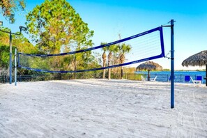 A beach volleyball court with a net, surrounded by sand and palm trees. - Great Amenities 3 BD/ 2 BA/ Bahama Bay - 605 NP (Davenport)