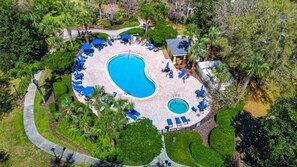 An aerial view of a resort with a central swimming pool surrounded by lounge chairs and palm trees. - Great Amenities 3 BD/ 2 BA/ Bahama Bay - 605 NP (Davenport)