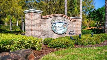 A brick wall with a sign for 'Bahama Bay Resort' and a logo.
