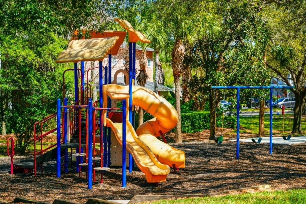 A playground with a slide and climbing structures.
