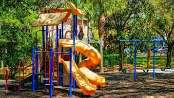 A playground with a slide and climbing structures.