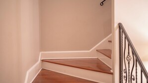 A staircase with wooden steps and a metal railing.
