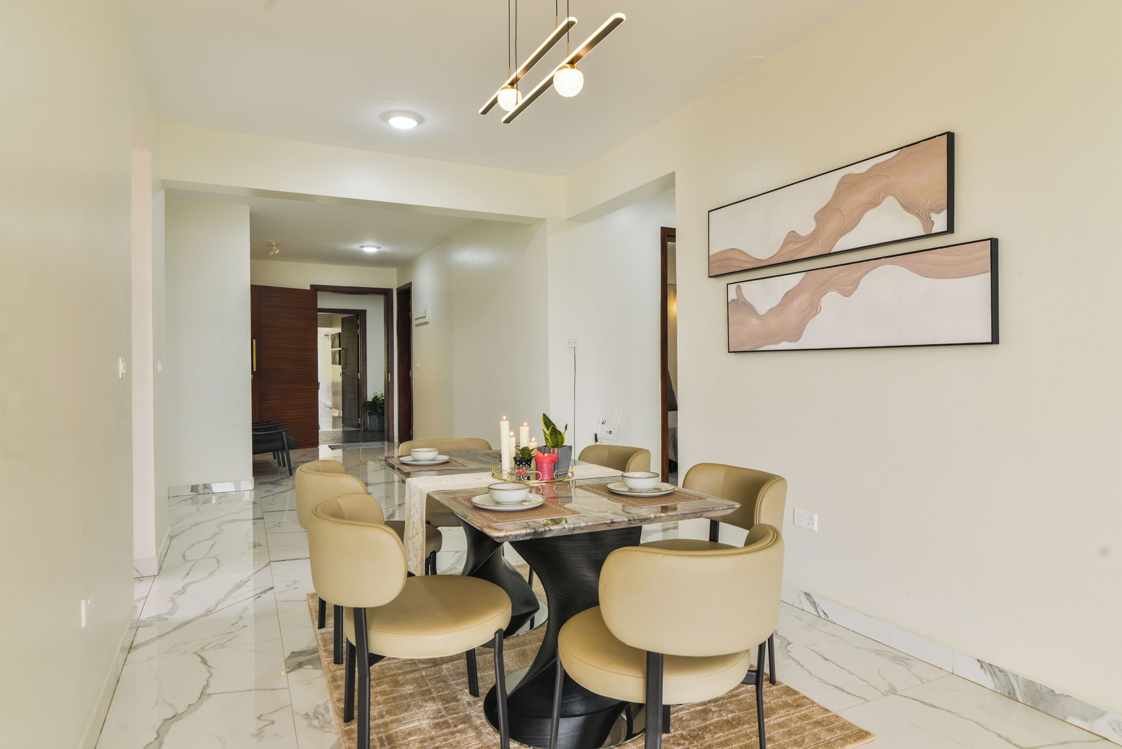A dining area with a marble floor, a table set for four, and modern chairs.
