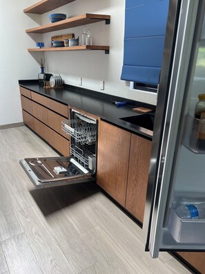 A modern kitchen with wooden cabinets, a black countertop, and a dishwasher. - Golfers paradise @ hole 1, Chapala country club.

Luxury living at it’s finest. (Vista del Lago)