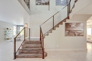 A staircase with a wooden finish and metal railings, leading to a higher floor. - Extraordinary 6-bedroom house with in vibrant South west Las Vegas (Las Vegas)