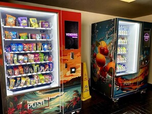 A vending machine with a variety of snacks and beverages. - New Waikiki 2BR •Walk to Beach +free parking (Honolulu)