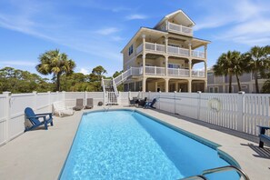 A two-story building with a pool and outdoor seating. - The Blue Pelican New-SGI- POOL - Sleeps 12 (Eastpoint)