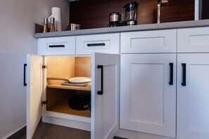 A kitchen with white cabinets, a countertop, and a built-in oven. - New Listing • Prime Location • Cozy & Modern (Cabo San Lucas)