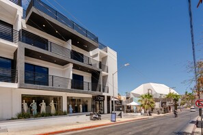 A modern building with a ground floor featuring a boutique store and a restaurant. - New Listing • Prime Location • Cozy & Modern (Cabo San Lucas)