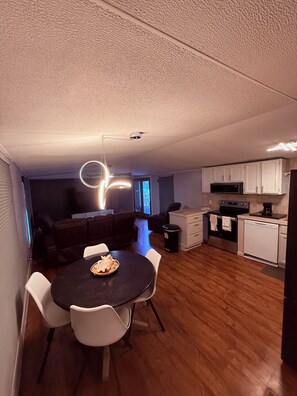 A modern kitchen with white cabinets, a microwave, and a dishwasher. - Gorgeous 3-bedroom mobile home with AC in Canyon Lake (Canyon Lake)