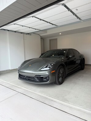 A car parked in a garage with a white ceiling and walls. - Ocean View Luxury Condo off Monterey Bay Brand New (Marina)
