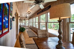 A long, narrow room with wooden floors, a bench, and a table with a lamp. - 4BR Beach House w/ Covered Porches, Game Room & Shared Creek Dock Access (Pawleys Island)