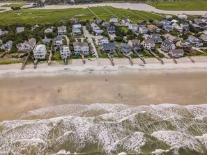 A coastal residential area with houses adjacent to a beach and ocean. - 4BR Beach House w/ Covered Porches, Game Room & Shared Creek Dock Access (Pawleys Island)