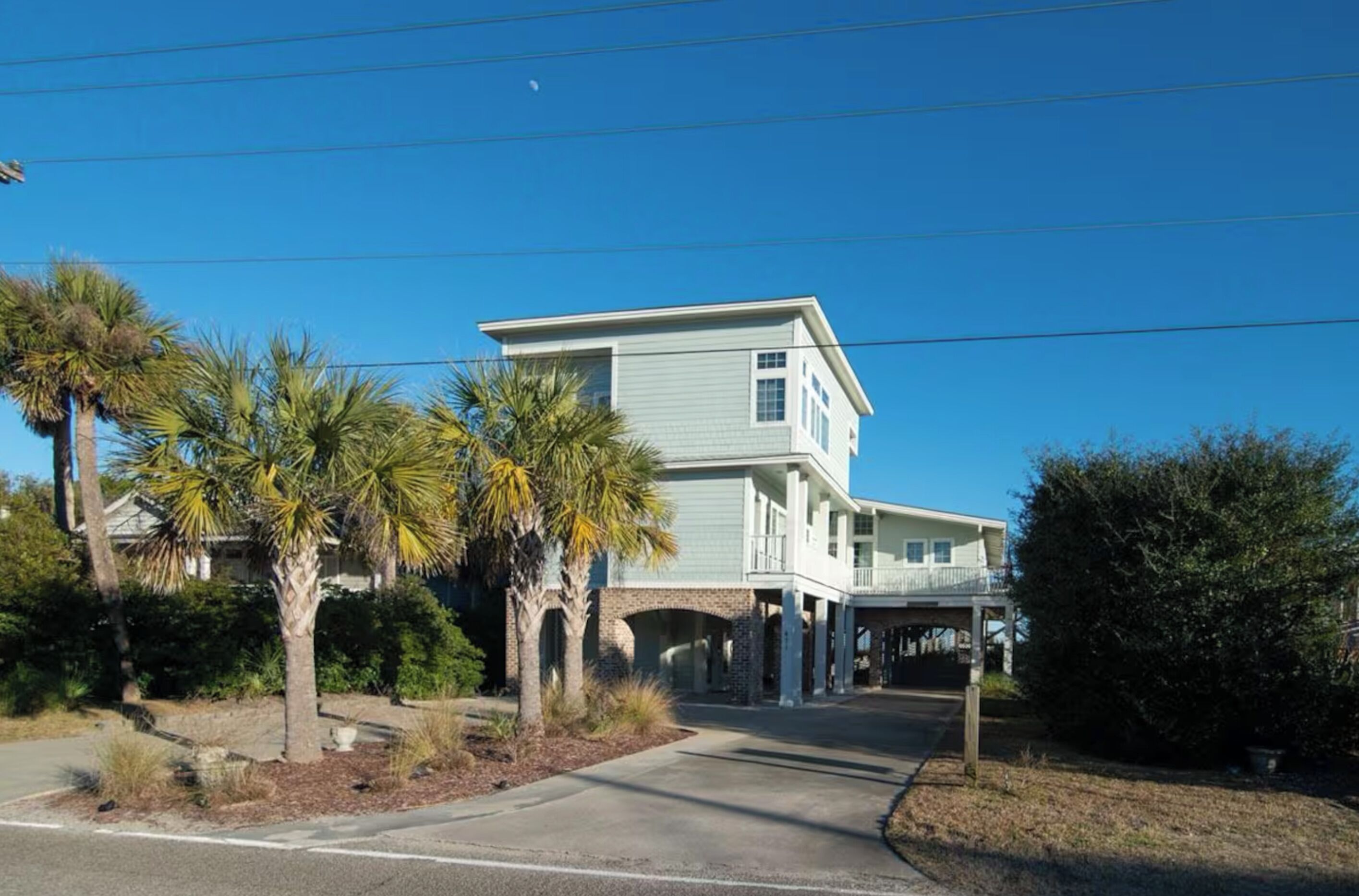 A two-story house with a covered porch and a garage.