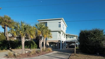 A two-story house with a covered porch and a garage.