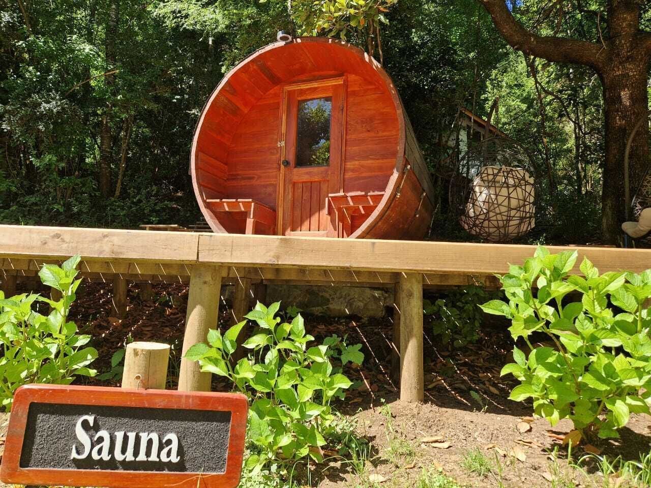 A sauna with a wooden exterior, a door, and a window.