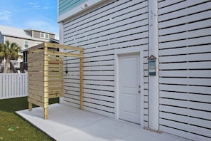 A building with a white exterior, a wooden pergola, and a white door. - Panoramic Ocean View Retreat Near South Litchfield Beach w/ Resort Access (Pawleys Island)