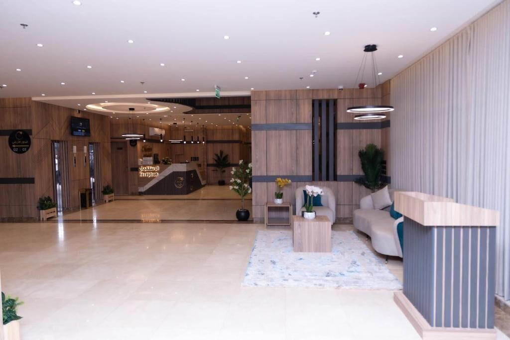 A modern reception area with a reception desk, seating, and a clear path to the entrance.