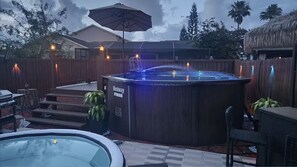 A hot tub with a wooden deck, a lounge chair, and a sign that reads 'Bestway'. - Charming Pool Home in Port Richey - Sleeps 6 (Port Richey)