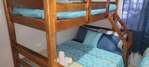 A bunk bed with a lower bunk and a mattress with patterned bedding.
