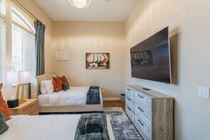 A bedroom with a bed, a dresser, a TV, and artwork on the wall. - TPC Golf Condo/Patio/Golf Course View/Sleeps 8/Community Pool/Hot Tub (Scottsdale)