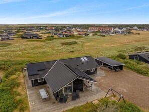 A modern house with a deck, solar panels, and a carport. - "Arsi" - 350m from the sea by Interhome (Thisted)