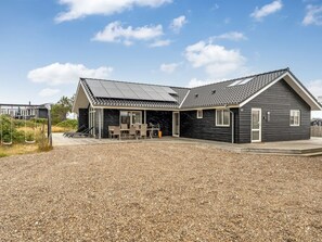 A modern two-story house with a covered patio and solar panels. - "Arsi" - 350m from the sea by Interhome (Thisted)