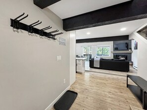 A modern interior with a black and white color scheme, a kitchen area, and a seating area with a view. - Family-Friendly 3BR Vail Condo near Gore Creek, Steps to Free Bus, 2 Parking Spaces (Vail)