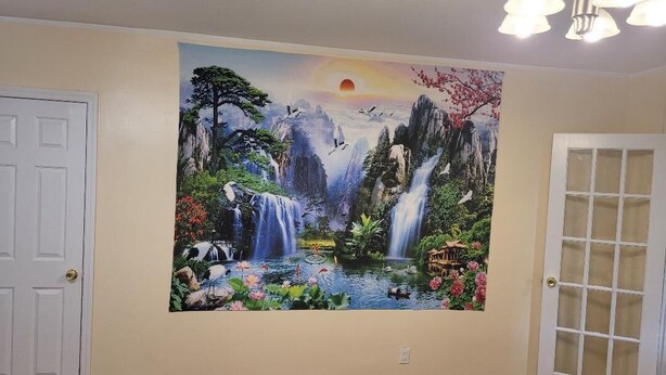 A room with a large wall mural of a natural landscape, a white door, and a chandelier. - BEAUTIFUL 1 BEDROOM WITH BACKYARD (FOREST HILLS)