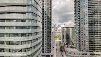 A modern high-rise building with multiple balconies and a curved facade.