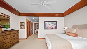 A bedroom with a bed, dresser, ceiling fan, and artwork on the wall. - Poipu Kapili Condo 4 by Alekona Kauai - 2BR Oceanfront (Koloa)