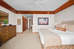A bedroom with a bed, dresser, ceiling fan, and artwork on the wall. - Poipu Kapili Condo 4 by Alekona Kauai - 2BR Oceanfront (Koloa)