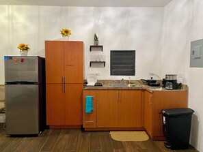 A compact kitchen with a refrigerator, microwave, and sink. - 2-bedroom house in awesome Aguadilla with cool AC (Aguadilla)