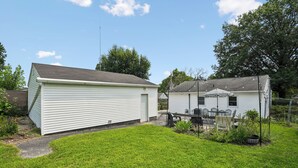 A two-story residential building with a covered patio area. - Cedar Grove Oasis:  Huge Private Yard + Gazebo (Cedar Rapids)