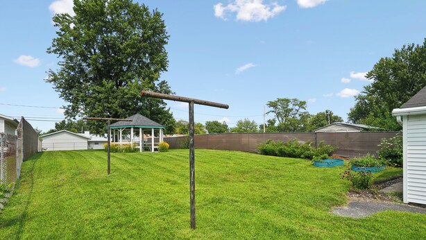 A backyard with a swing set, a gazebo, and a fenced area. - Cedar Grove Oasis:  Huge Private Yard + Gazebo (Cedar Rapids)