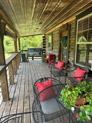 A wooden deck with outdoor seating, a grill, and potted plants. - cozy mountain retreat with wood stove and hot tub (Mena)