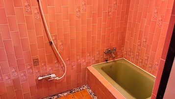 A bathroom with a shower, a bathtub, and a tiled floor.