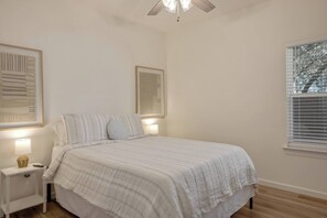 A bedroom with a bed, bedside tables, a ceiling fan, and a window with blinds. - Freetown Farmhouse | Modern 3BR w/Big Kitchen (Lafayette)