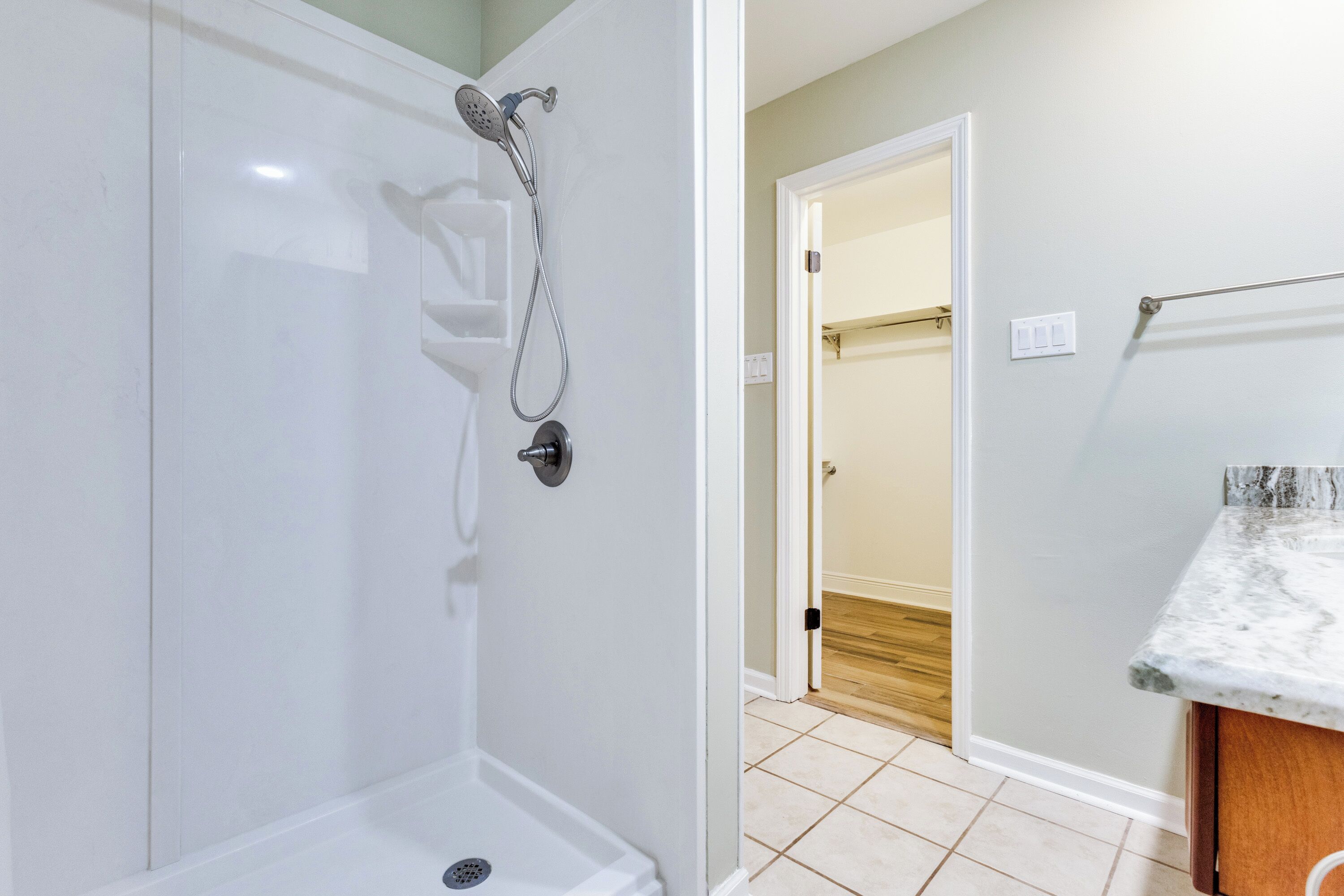 A bathroom with a shower, toilet, and sink.