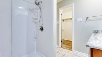 A bathroom with a shower, toilet, and sink.
