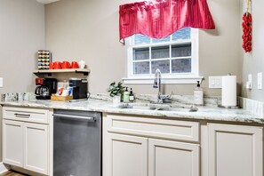 A kitchen with a dishwasher, a coffee maker, and a sink. - NEW! Kid Friendly 3BR Fenced Yard - Sports Complex (Youngsville)