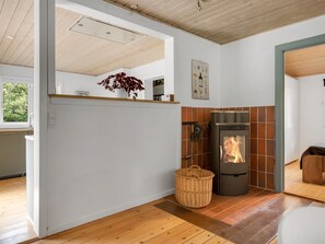 A modern kitchen with a wood-burning stove, a large window, and a dining area. - "Elenora" - 200m from the sea by Interhome (Odder)