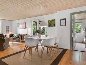 A modern living room with a dining area, wooden floors, and a large window. - "Elenora" - 200m from the sea by Interhome (Odder)
